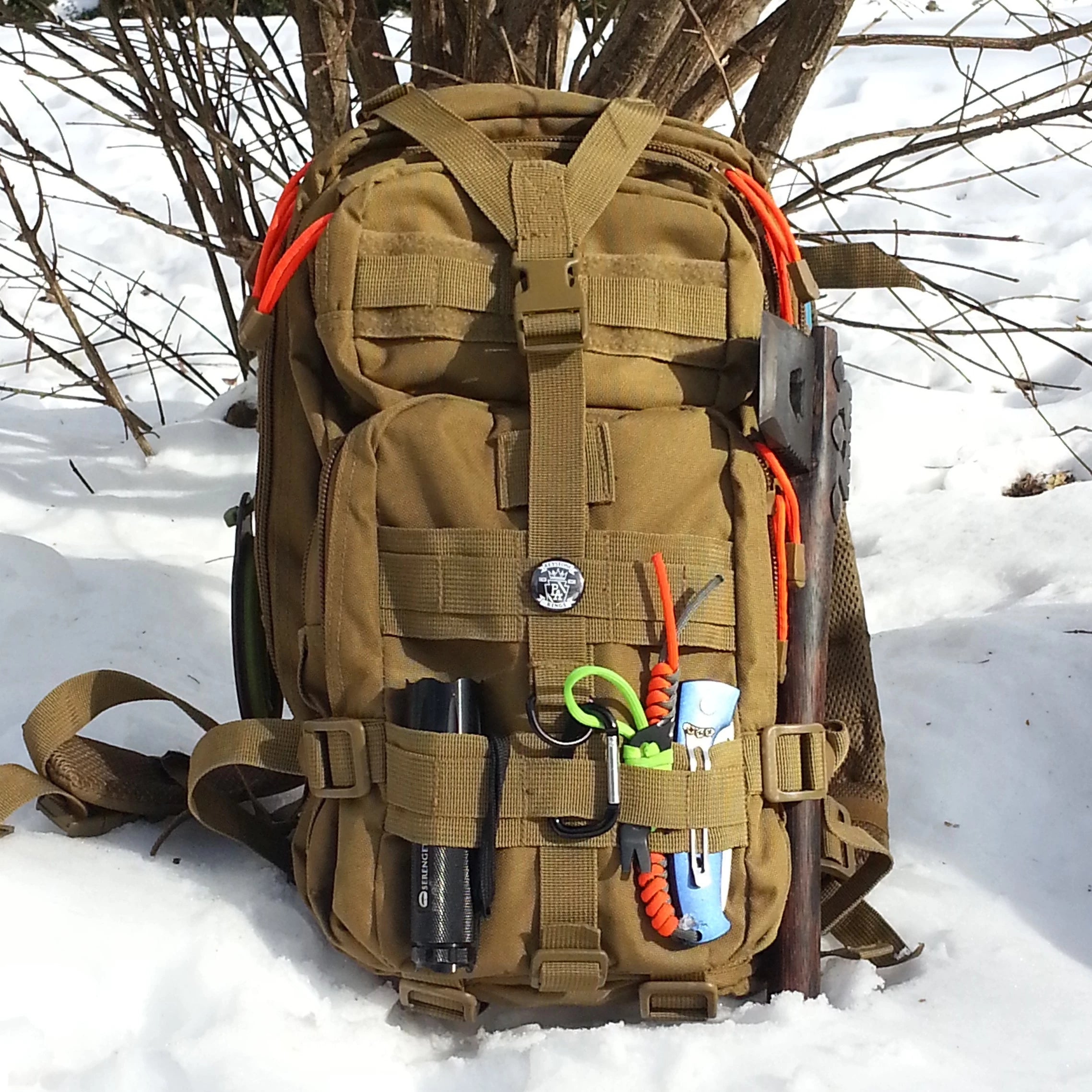 Brown tactical backpack with tools in the snow