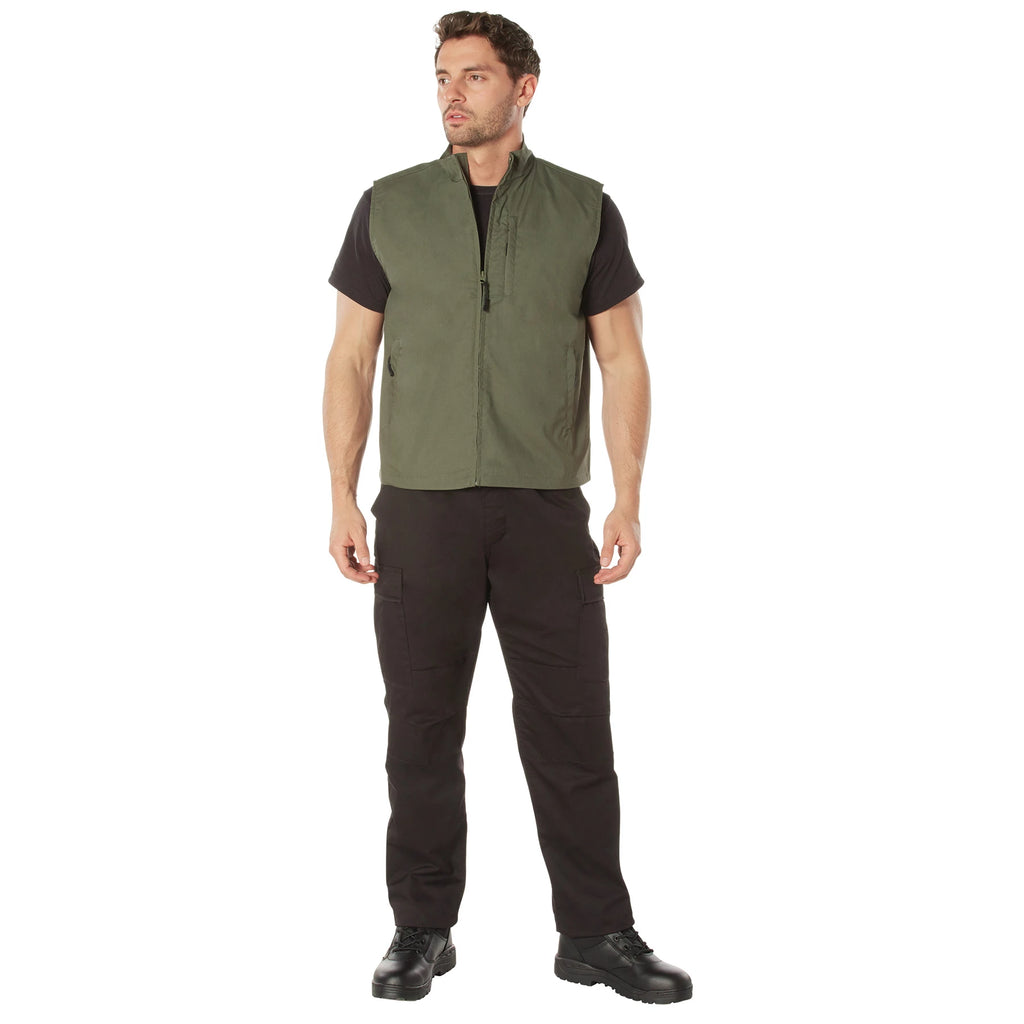Man wearing a green vest and black pants on a white background