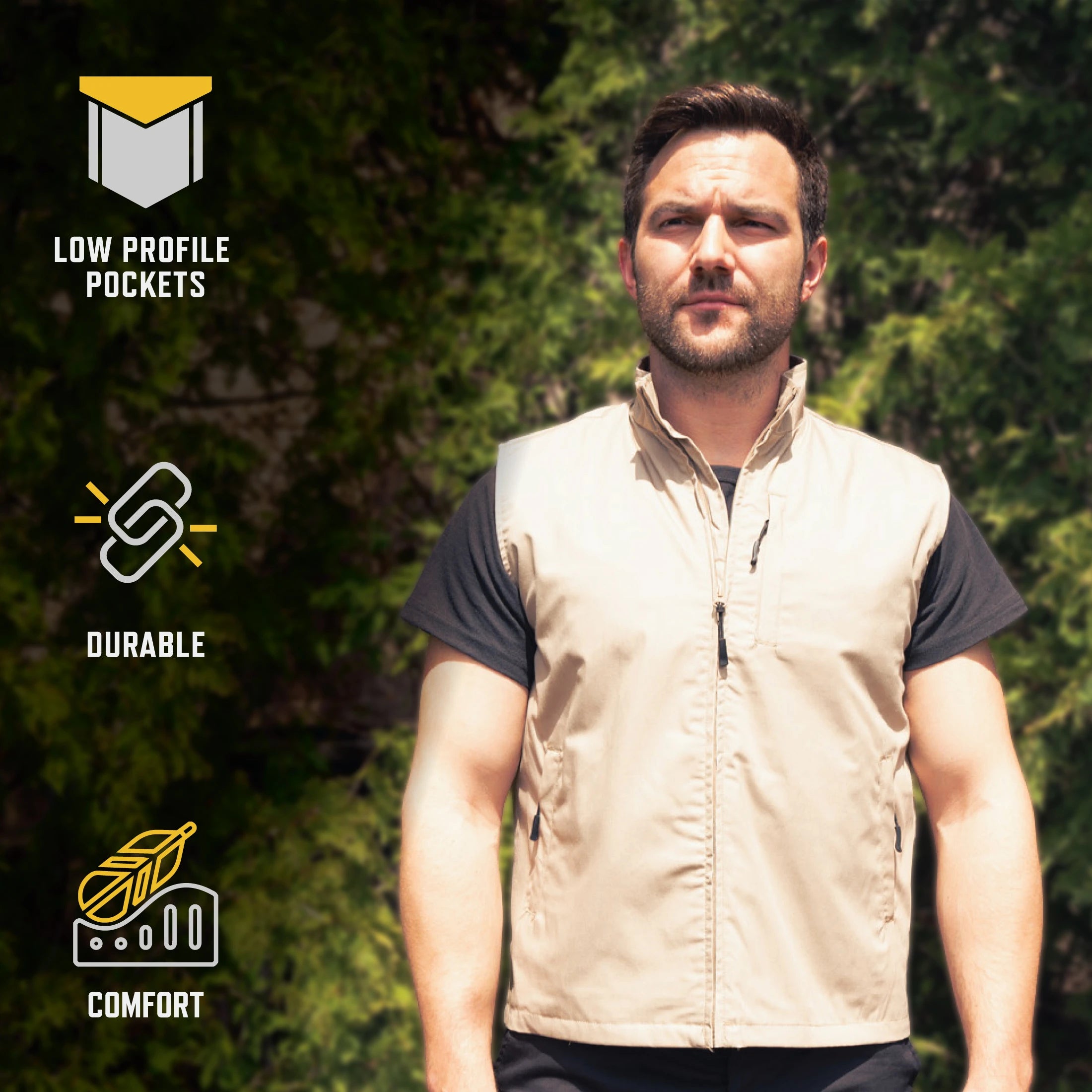 A man wearing a beige zip-front vest over a black t-shirt stands outdoors in front of green trees. Three feature callouts appear on the left: 'LOW PROFILE POCKETS' with an open pocket icon, 'DURABLE' with a chain icon, and 'COMFORT' with a cushion icon.