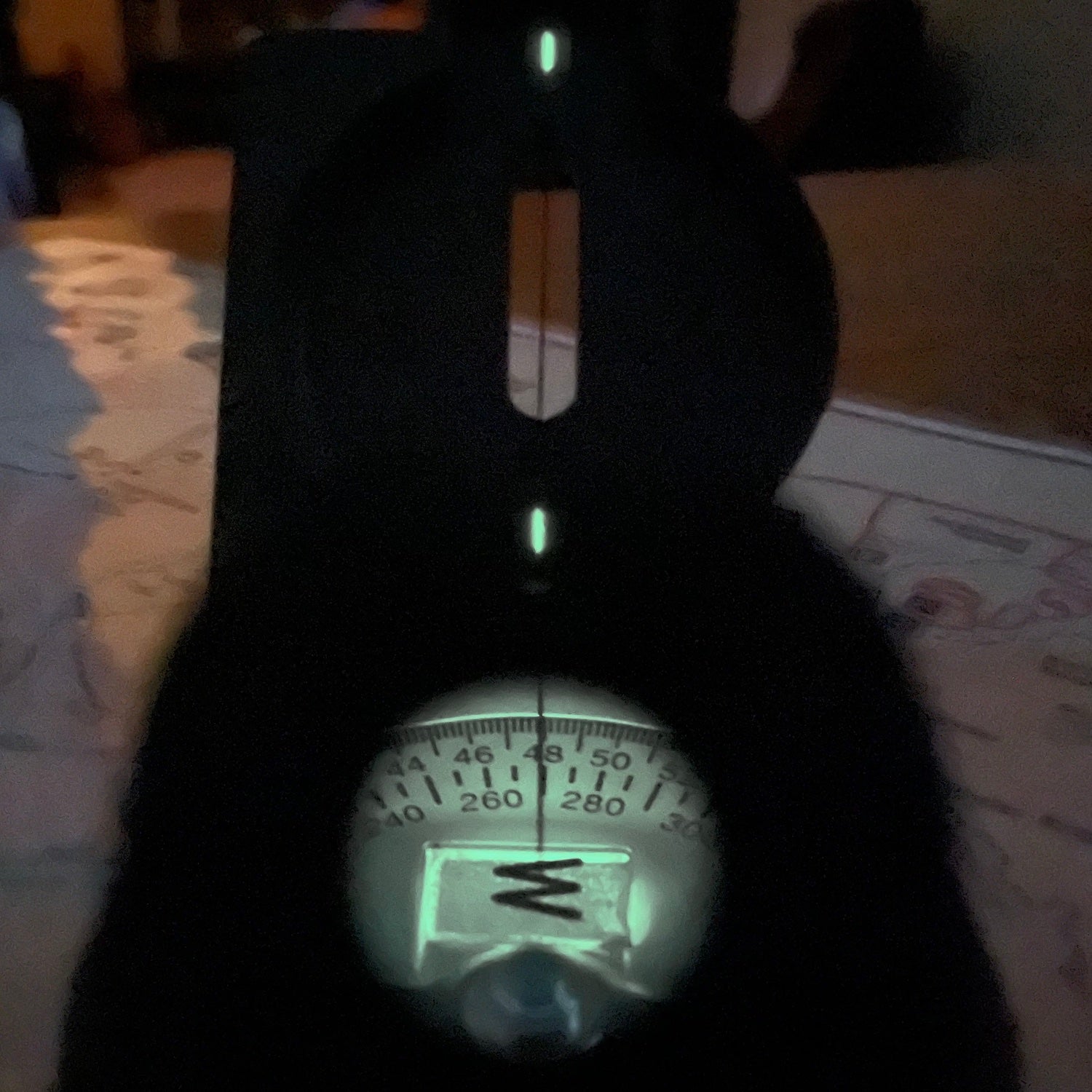 Cammenga Special Tritium Lensatic Compass, sight line night view showing the dial as seen through the sighting lens, sight wire and radioluminescent sight line markers.