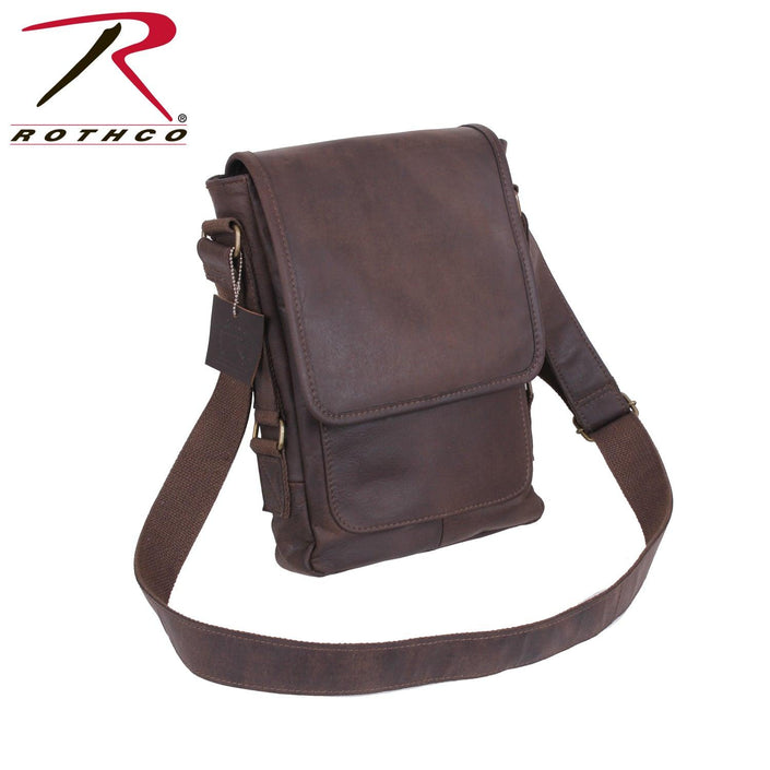 Rothco's Brown Leather Military Tech Bag, oblique front view showing shoulder sling and weather flap closed.